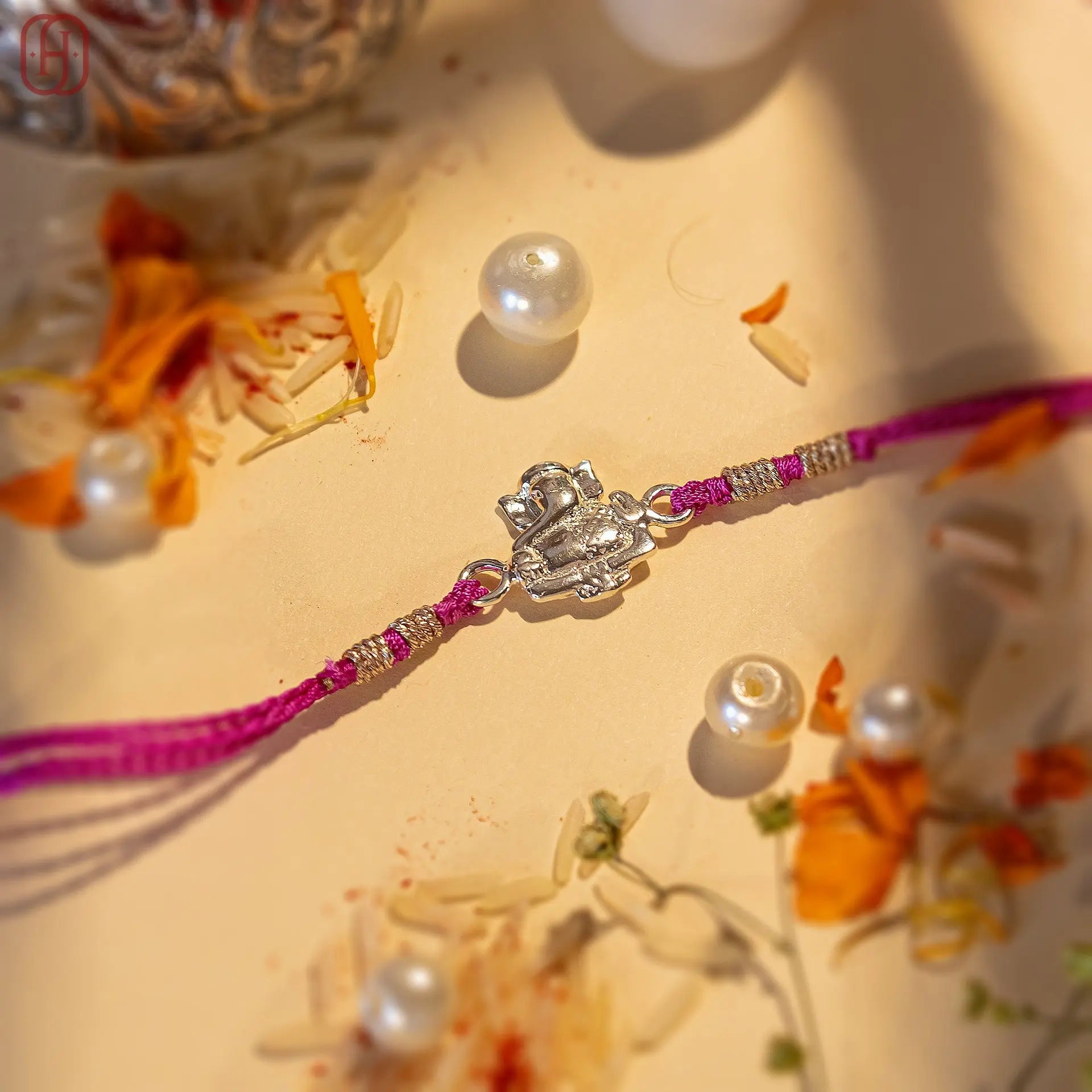 Ganesh Ji face rakhi in silver with purple thread and silver beads by Hardik Jewels