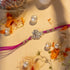 Ganesh Ji face rakhi in silver with purple thread and silver beads by Hardik Jewels