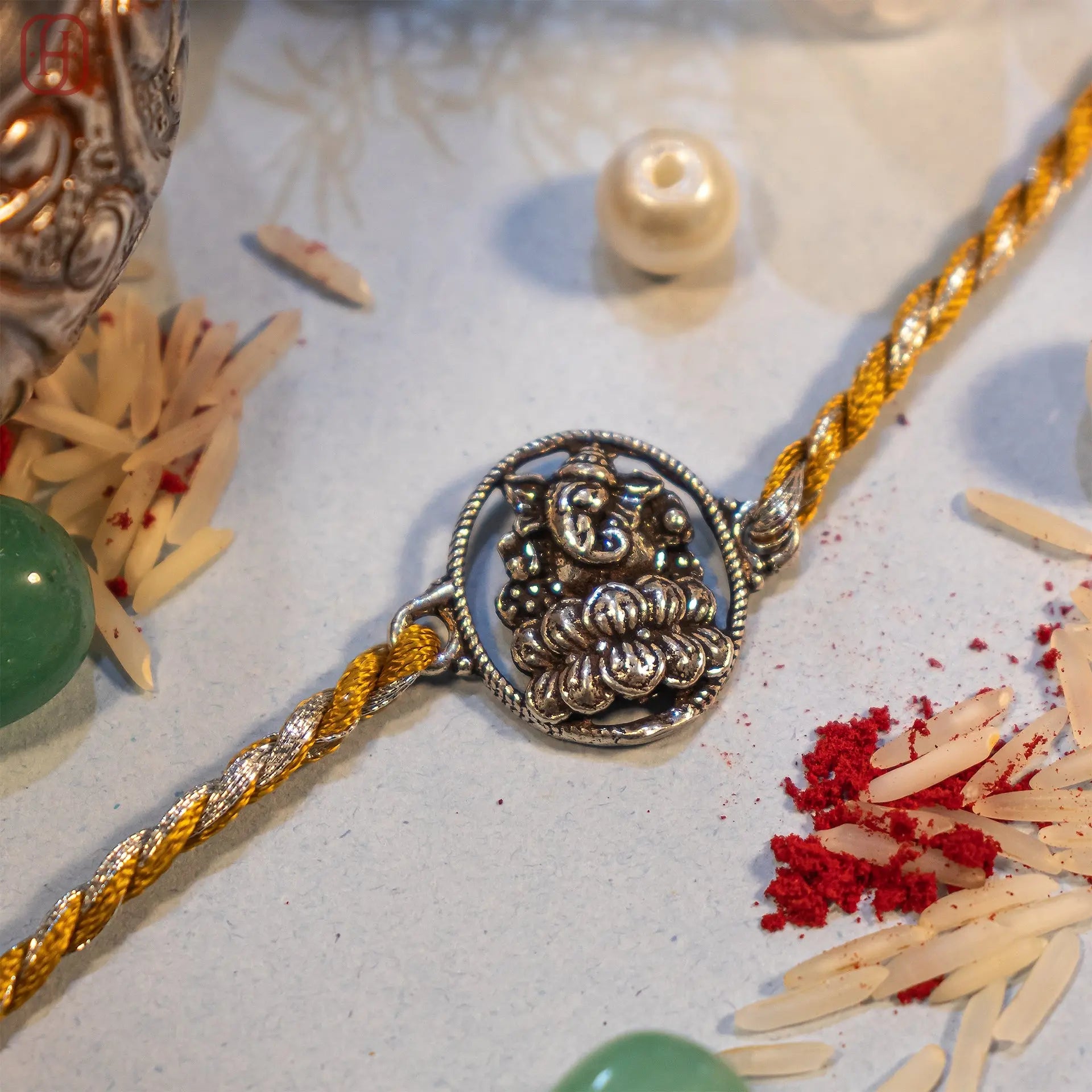 Premium Ganesh Ji silver rakhi with ornate frame on gold-silver thread - Hardik Jewels