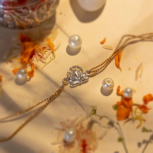 Ganesh silver rakhi online with detailed silver Ganesh charm and golden thread by Hardik Jewels