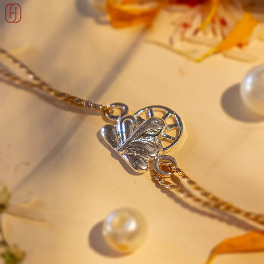 Ganesh silver rakhi online with intricate silver pendant on golden thread by Hardik Jewels
