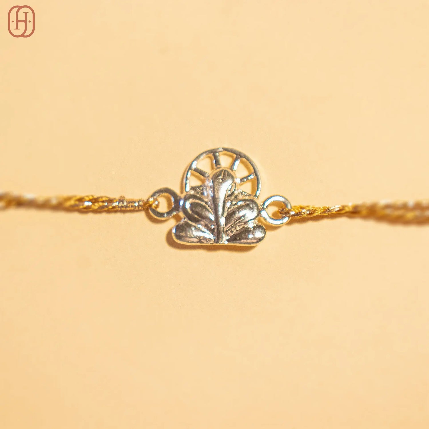 Ganesh silver rakhi online with intricate silver charm and golden thread by Hardik Jewels