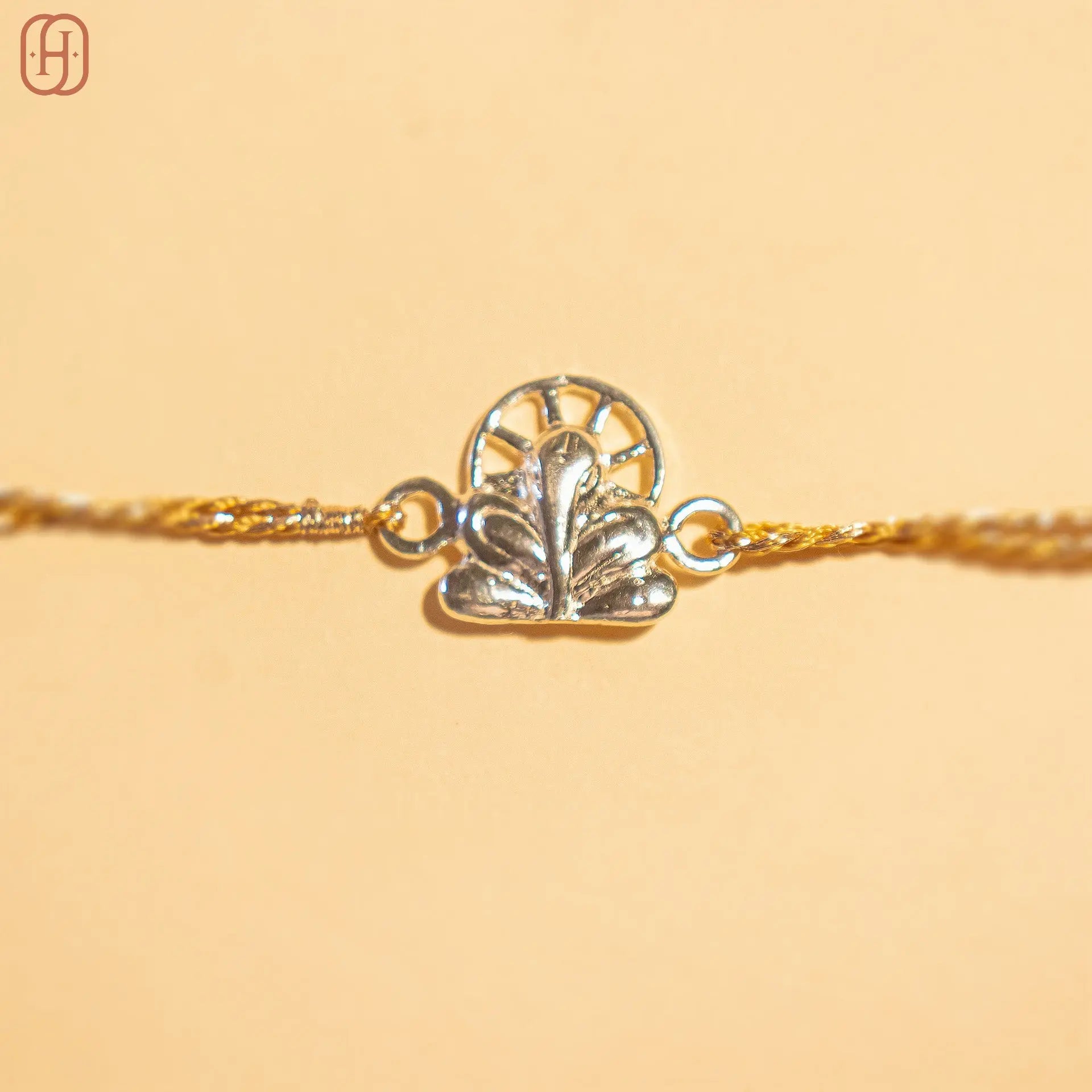 Ganesh silver rakhi online with intricate silver charm and golden thread by Hardik Jewels