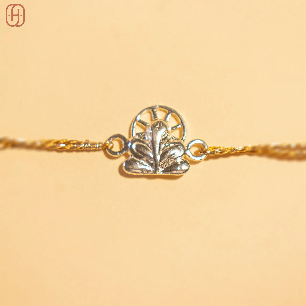 Ganesh silver rakhi online with intricate silver charm and golden thread by Hardik Jewels