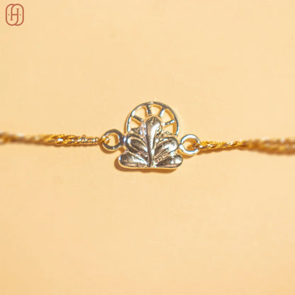 Ganesh silver rakhi online with intricate silver charm and golden thread by Hardik Jewels