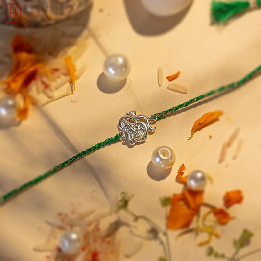 92.5 silver rakhi for brother with green thread and silver Ganesh charm by Hardik Jewels