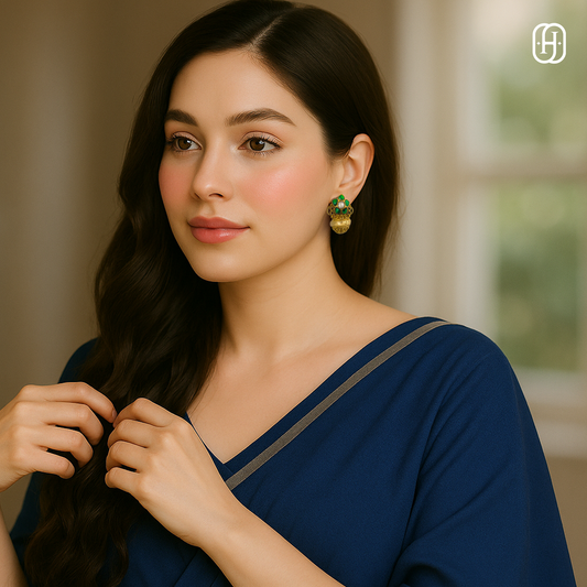 Elegant model wearing green stone Polki earrings styled with a blue outfit for a sophisticated look
