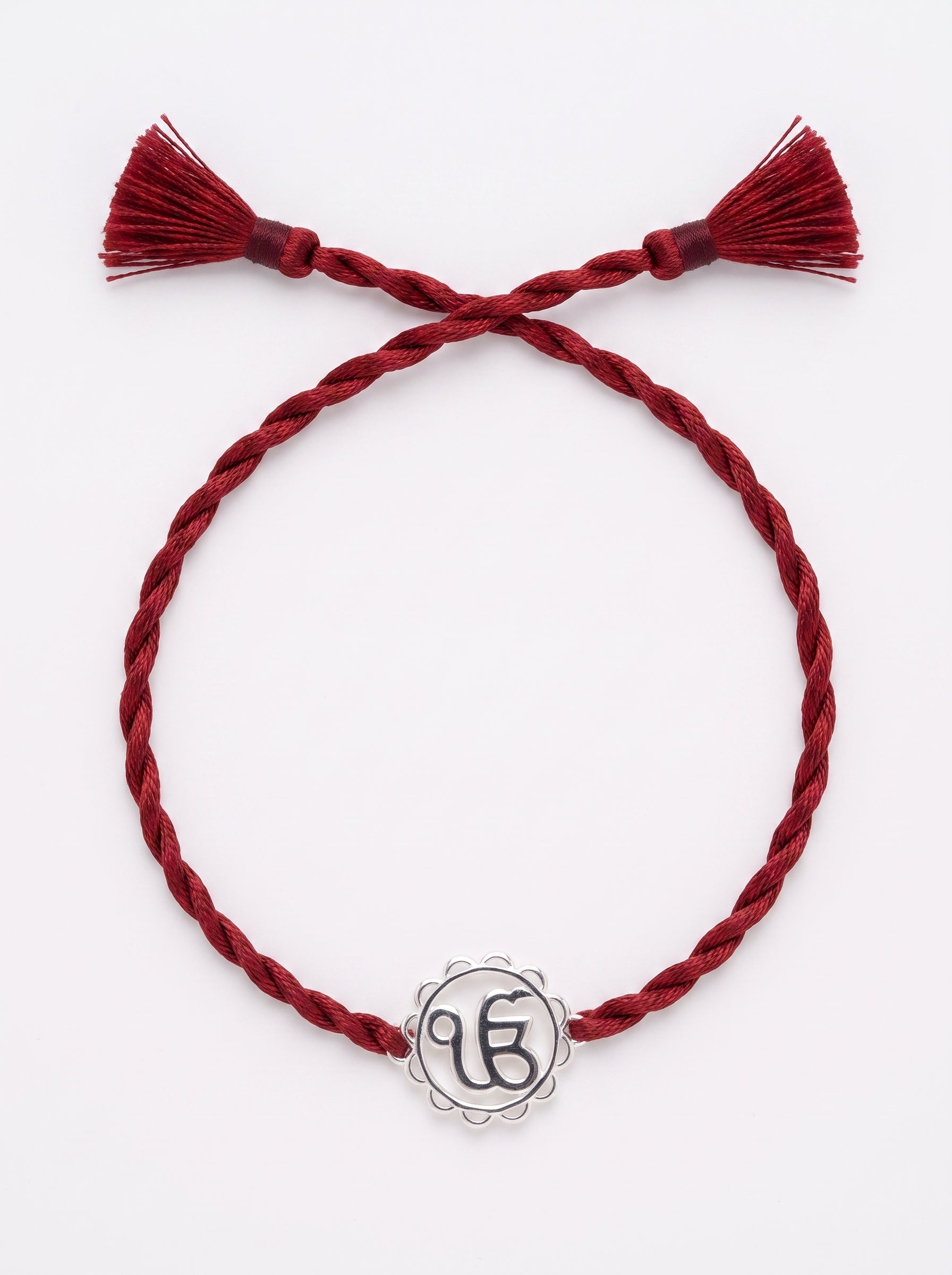 Ik Onkar Silver Rakhi - Maroon Thread - studio product photo - Hardik Jewels