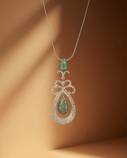Elegant pendant with a green gemstone pendant on a brown background