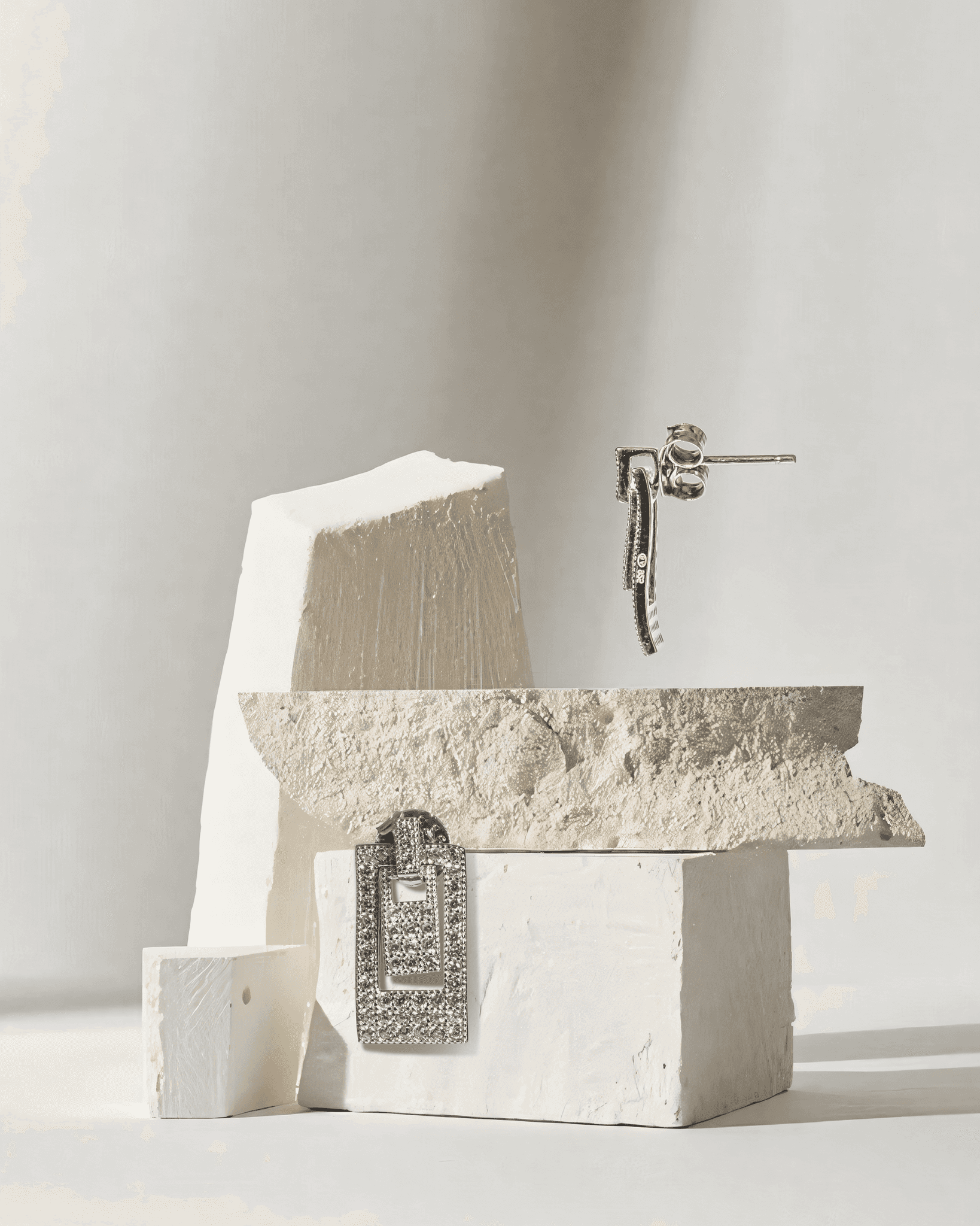 Decorative stone sculpture with a metallic lock on a light gray background