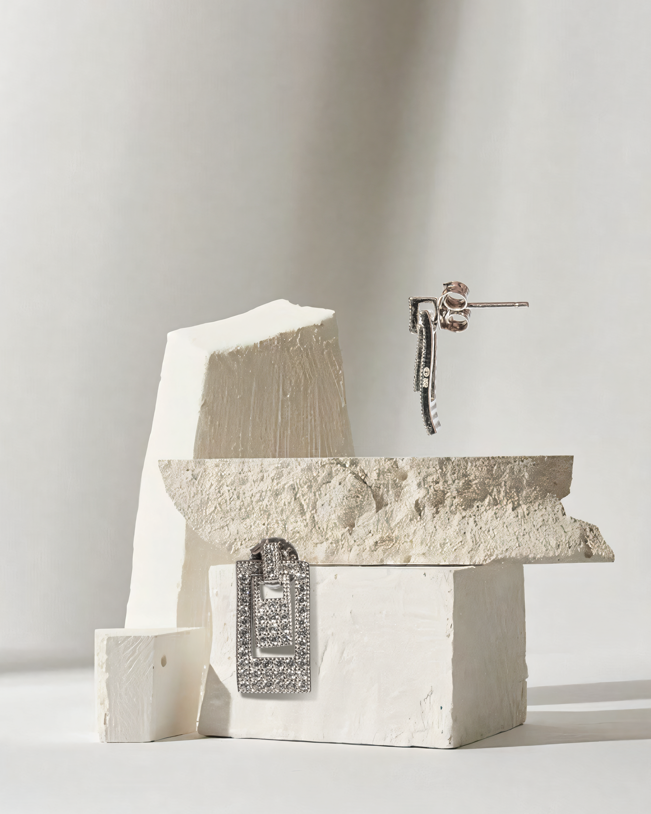 Decorative stone sculpture with a metallic lock on a light gray background