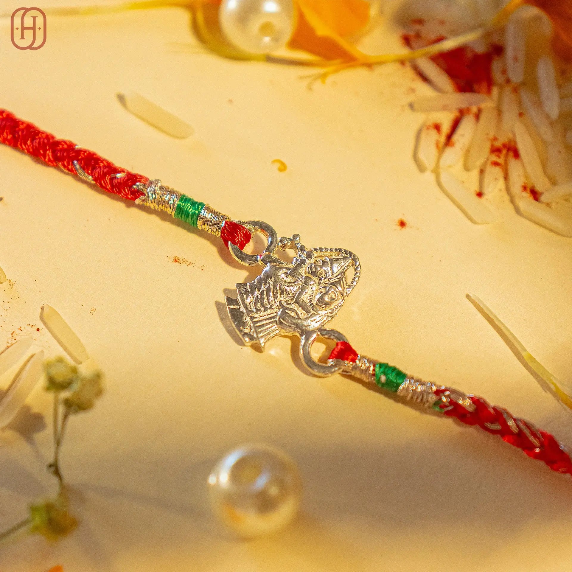 Rakha krishna silver bracelet rakhi with red thread and intricate silver deity charm by Hardik Jewels