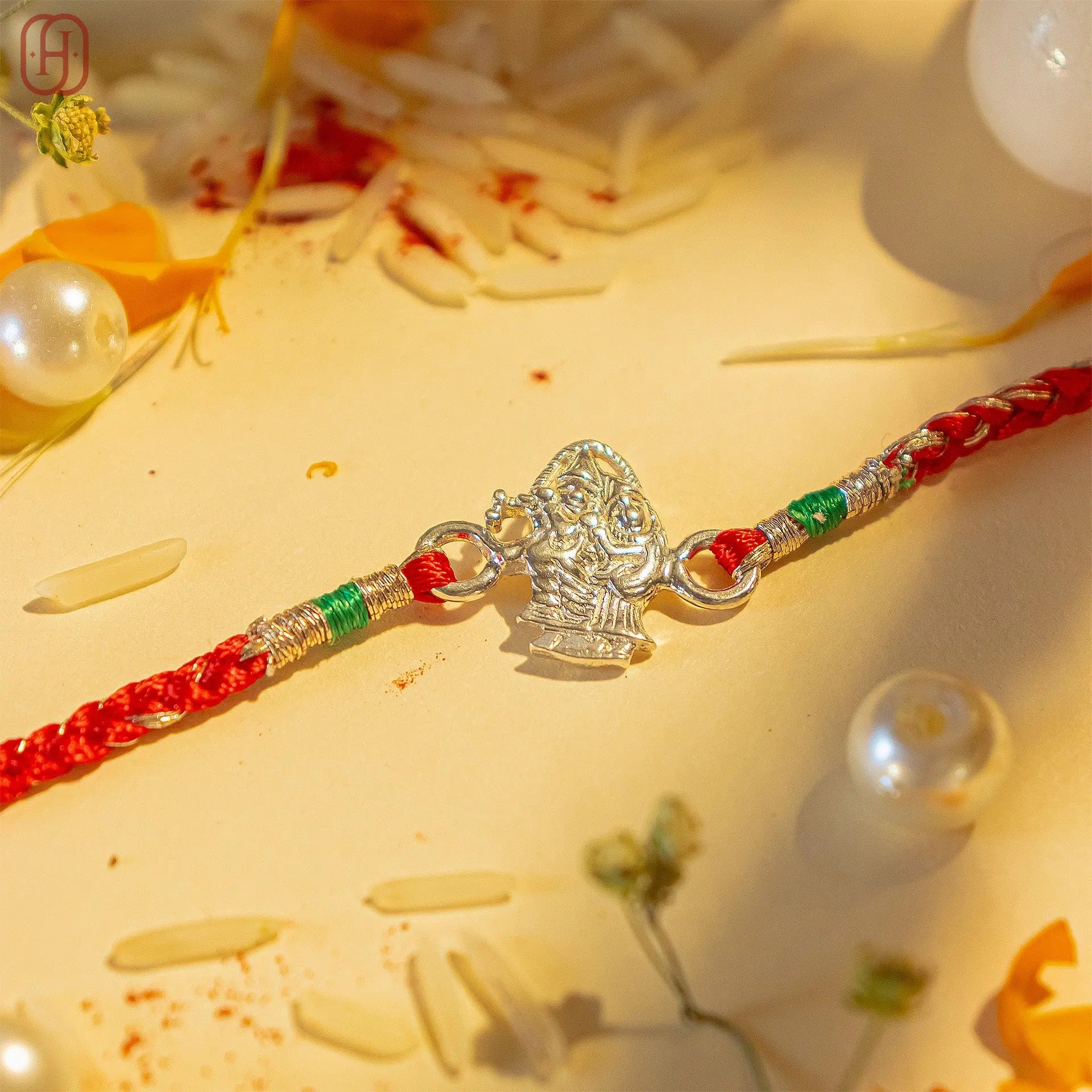 Rakha krishna silver bracelet rakhi with red thread and detailed silver charm by Hardik Jewels