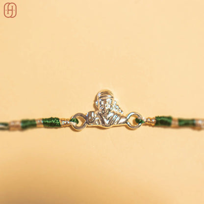 Sai Baba silver rakhi with detailed silver charm and green thread from Hardik Jewels