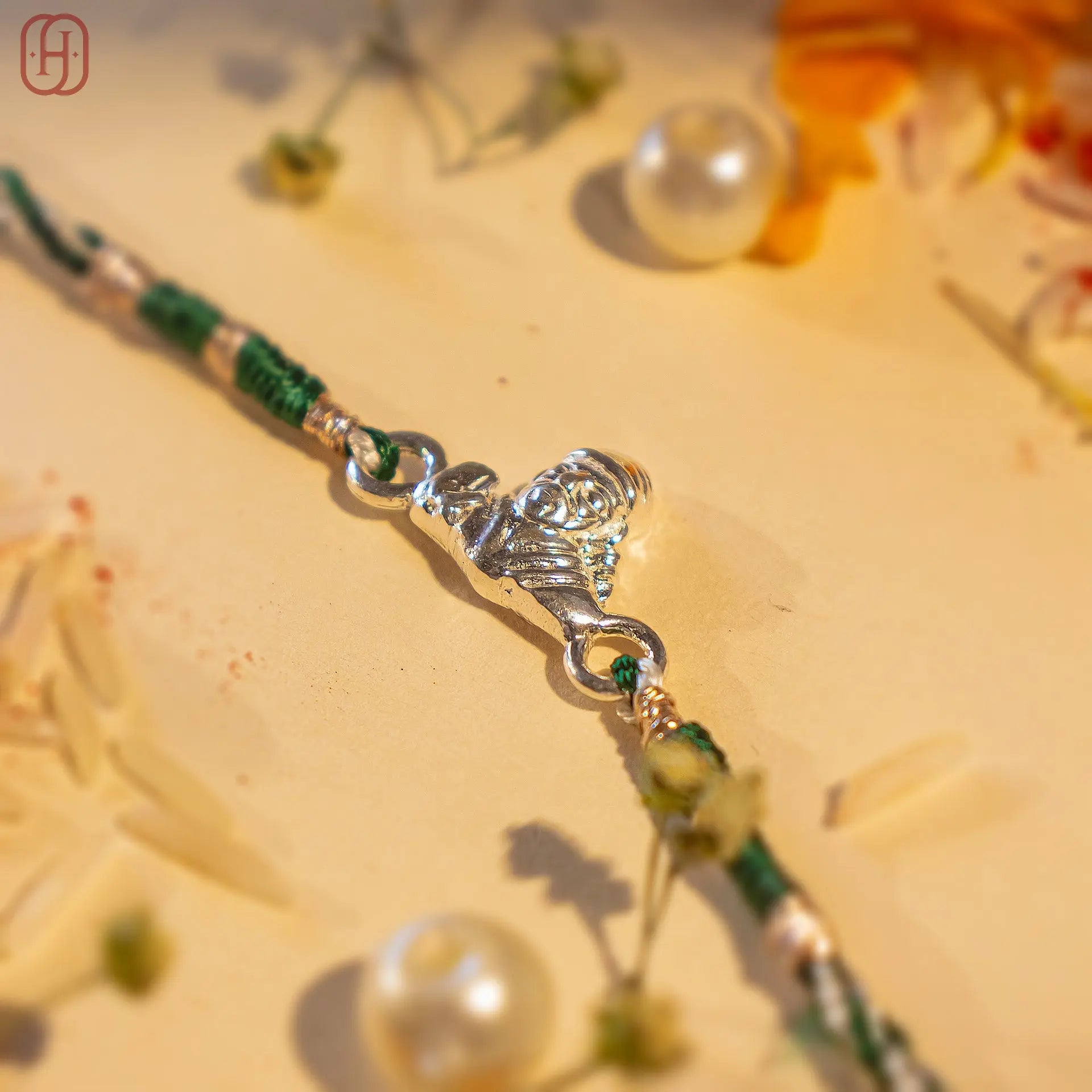 Sai Baba silver rakhi with detailed silver centerpiece and green thread by Hardik Jewels