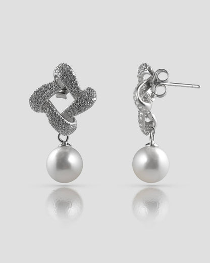 Front and back profile view of silver twisted knot pearl drop earrings showing the push-back closure.