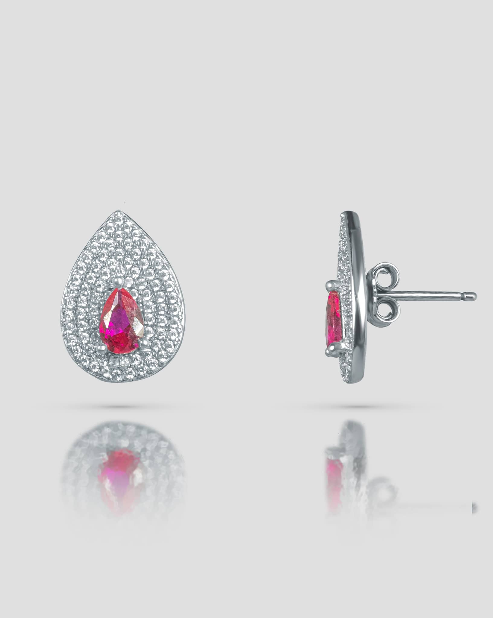 Front and side profile view of silver teardrop stud earrings showcasing the pink cz center, clear cz pave surface, and push-back closure.
