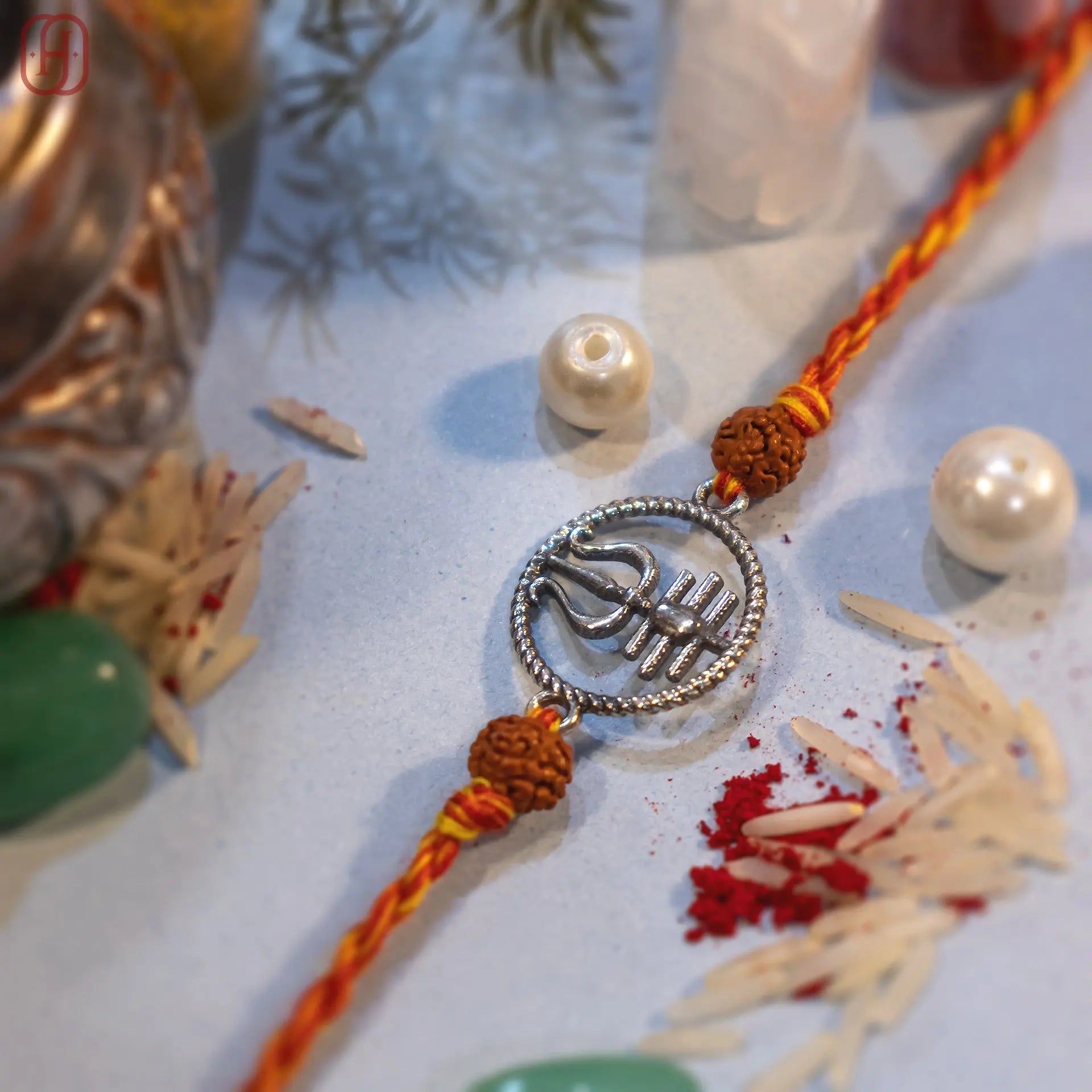 Silver Trishul rakhi with rudraksha beads on orange mauli thread - Hardik Jewels