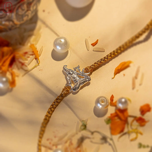 Unique Shiva rakhi for brothers with silver Shiva pendant on golden braided thread by Hardik Jewels