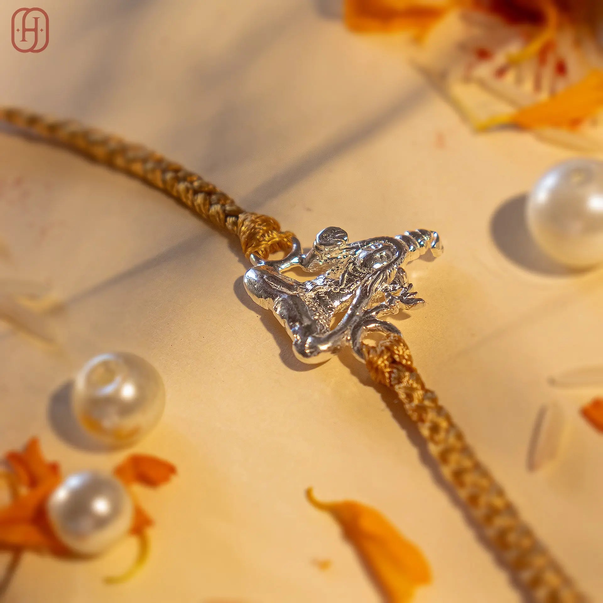 Unique Shiva rakhi for brothers with silver Shiva charm on golden braided thread from Hardik Jewels